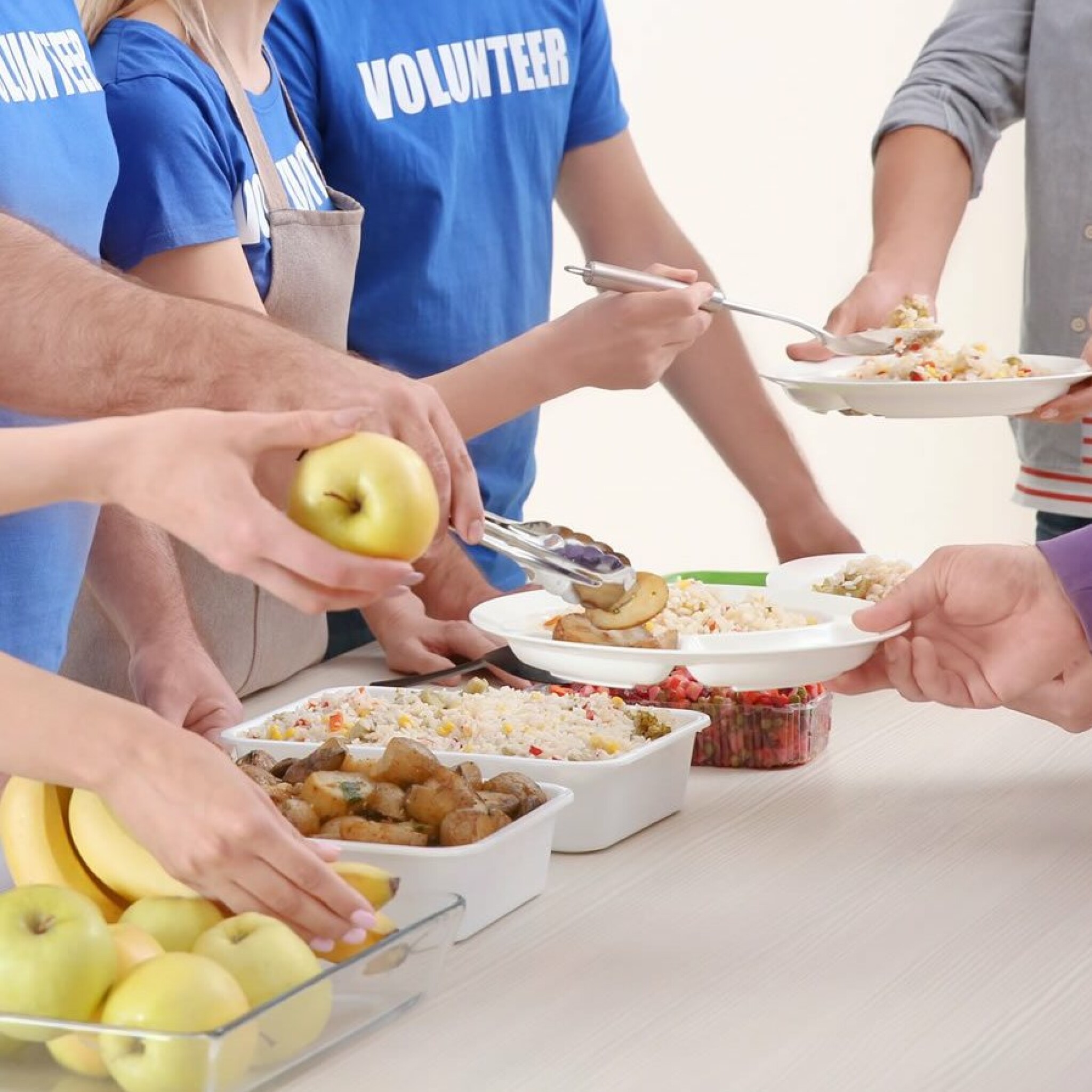 young-volunteers-serving-food-to-homeless-people.jpg